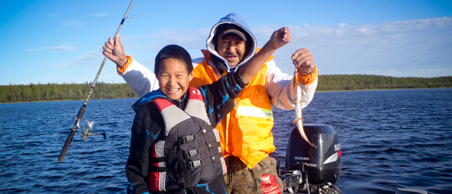 George St. Pierre and Dalten Denechezhe fishing on Wollaston Lake<br>Photo courtesy of CanNorth